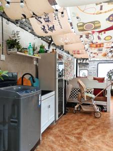 a kitchen with a childs stroller in a room at In Spring Country Courtyard in Lijiang in Lijiang