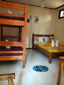 a bedroom with two bunk beds and a ladder at Jenises Inn in El Nido +16 photos