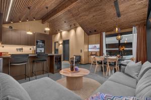 a living room with a couch and a table at Signature Townhouse for Luxury Living Arctic Seasons in Tromsø
