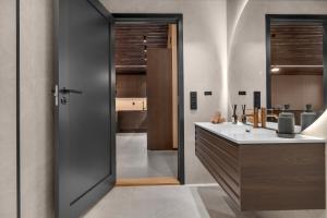 a bathroom with a sink and a counter with a mirror at Signature Townhouse for Luxury Living Arctic Seasons in Tromsø +23 photos