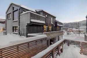 a building in the snow with snow on it at Signature Townhouse for Luxury Living Arctic Seasons in Tromsø
