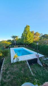 a swimming pool in the yard of a house at Terrazas al Golf in Alta Gracia