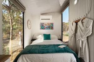 a bedroom with a bed and a large window at Womburra Vineyard Tiny Stay by Tiny Away in Redbank
