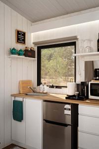 a kitchen with a sink and a window at Womburra Vineyard Tiny Stay by Tiny Away in Redbank +15 photos