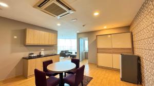 a kitchen with a table and chairs in a room at D Gateway Perdana Hotel Bangi in Bangi