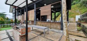 a building with a bench on a patio at D Pine Villa in Bukit Tinggi +1 photo