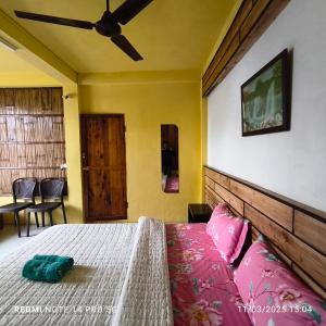 a bedroom with a bed and a ceiling fan at West corner homestay in Shillong