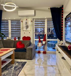 a living room with a couch and christmas decorations at Golden Luxury Suite in Nowy Dwór Mazowiecki
