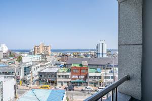 a view of a city from a balcony at Hotel memory Jumunjin- Welcome drink provided in Gangneung