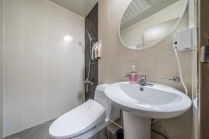 a bathroom with a sink and a toilet and a mirror at Hotel memory Jumunjin- Welcome drink provided in Gangneung +21 photos