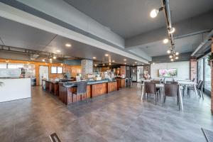 a restaurant with a bar and tables and chairs at Hotel memory Jumunjin- Welcome drink provided in Gangneung