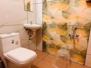 a bathroom with a toilet and a sink at hello 6 cliff stay varkalacliff - cozy rooms , couple friendly ,family ,group rooms in Varkala +54 photos