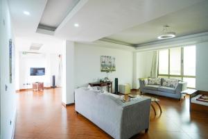 a living room with a couch and a table at Seaclusion Diani in Diani Beach