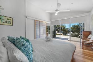 a bedroom with a bed with a stuffed animal on it at Hyams Reflections Hyams Beach in Hyams Beach