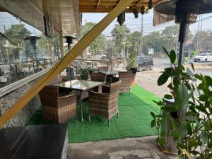 a table and chairs sitting outside of a restaurant at City Oasis Boutique Hotel in Lahore