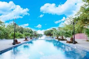 a swimming pool at a resort with a blue sky at Sai Gon Dong Ha Hotel - a member of Saigontourist Group in Quang Tri