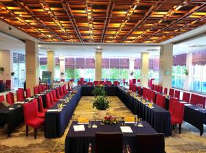 a conference room with long tables and red chairs at Sai Gon Dong Ha Hotel - a member of Saigontourist Group in Quang Tri +60 photos