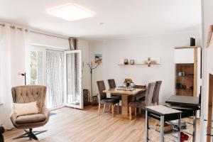 a dining room with a table and chairs at HOME AM SEE Ferienwohnung in Möhnesee