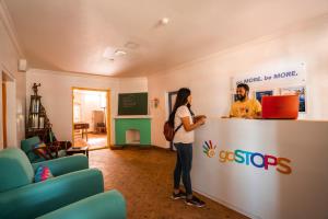 a man and a woman standing at a counter at goSTOPS Ooty in Ooty