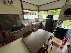 a kitchen with a table and a sink and a stove at ほしのすみか in Nikko +12 photos