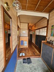 an inside view of a tiny house with shoes on the floor at ほしのすみか in Nikko