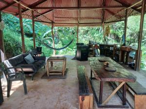 an outdoor living room with a table and chairs at Private jungle accommodation with waterfall in Minca +11 photos