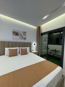 a bedroom with a large white bed and a balcony at Sirena Apartment Tangier in Tangier +58 photos