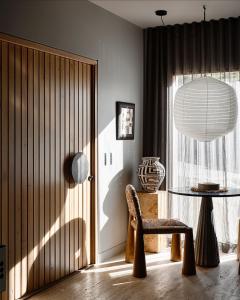 a room with a chair and a table and a window at Bassano Red Hill in Red Hill