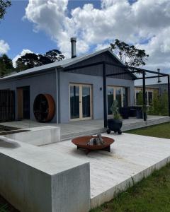 a house with a bench in front of it at Bassano Red Hill in Red Hill