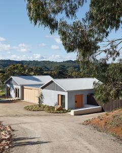 a white house with a grey roof and a driveway at Bassano Red Hill in Red Hill