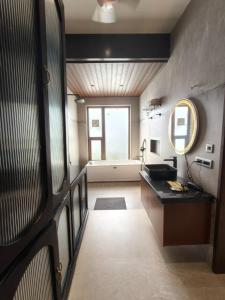 a bathroom with a sink and a mirror at Vaikunth Village Resort in Raipur