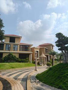 a house with a walkway in front of it at Vaikunth Village Resort in Raipur