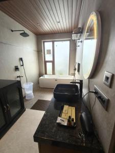 a bathroom with a sink and a toilet in a room at Vaikunth Village Resort in Raipur