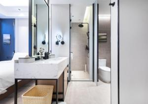 a bathroom with a sink and a toilet at Atour X Hotel Shenyang Beiling Park in Shenyang +27 photos