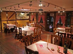 a restaurant with tables and chairs in a room at Hotel Kaiserquelle in Salzgitter