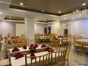 a banquet hall with tables and chairs with red napkins at Hotel Adelina Balanga City Bataan in Balanga