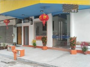 a store front of a building with a blue roof at H Sri Sayang Hotel Sdn Bhd in Skudai