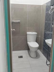 a bathroom with a toilet and a sink at H Sri Sayang Hotel Sdn Bhd in Skudai