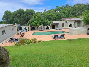 an image of a house with a swimming pool at Lodge Azure in Port Edward