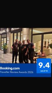 a group of men standing in front of a building at Ailana Hotel in Aqaba