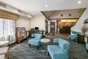 a hotel lobby with blue chairs and a waiting room at Sleep Inn Allentown-Fogelsville in Allentown