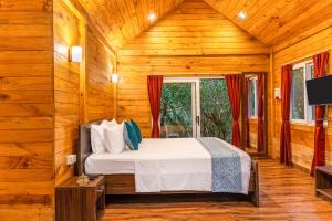 a bedroom with a bed in a wooden room at Nature Trails Rock Valley, Goa in Ponda +47 photos