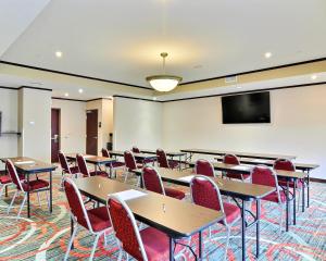 a classroom with tables and chairs and a projection screen at Comfort Suites Uniontown in Uniontown +40 photos