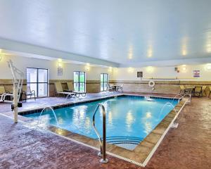 a large swimming pool in a hotel room at Comfort Suites Uniontown in Uniontown