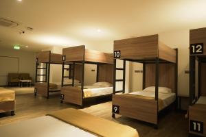 a room with four bunk beds in it at Round D Clock, IGI Airport in New Delhi
