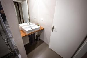 a bathroom with a white sink and a mirror at Hotel Opava - free parking in Opava +17 photos