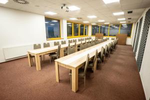 a classroom with rows of tables and chairs at Hotel Opava - free parking in Opava