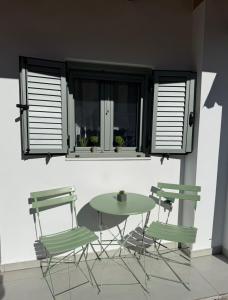 a table and chairs in a room with a window at Spitaki in Kremasti