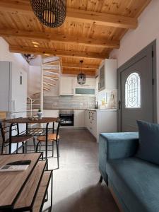 a living room with a blue couch and a table at Spitaki in Kremasti