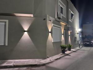 a building with lights on the side of a street at Siel simple elegance Volos in Volos